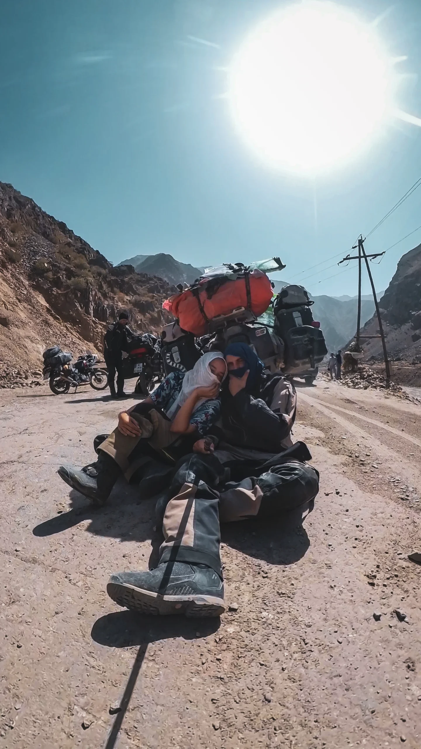 Vins and Natha sheltering from the Pamir heat in the shadow of Falkor