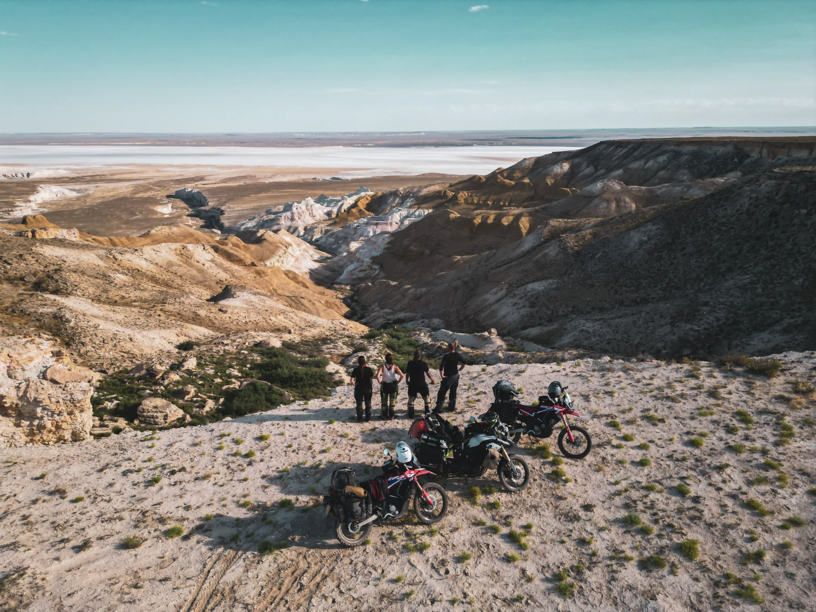 Four riders — Vins, Naya, Sander and Iris — setting off into the Mangystau Desert on the first day