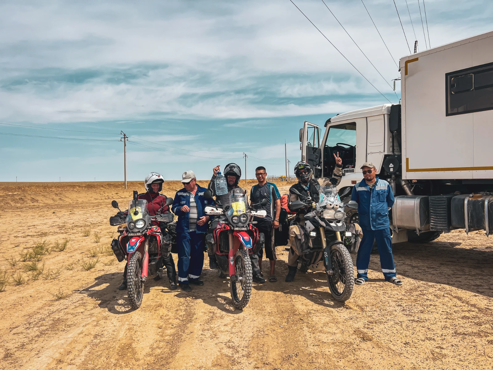 Kazakh truck workers offering water in the middle of the Mangystau Desert
