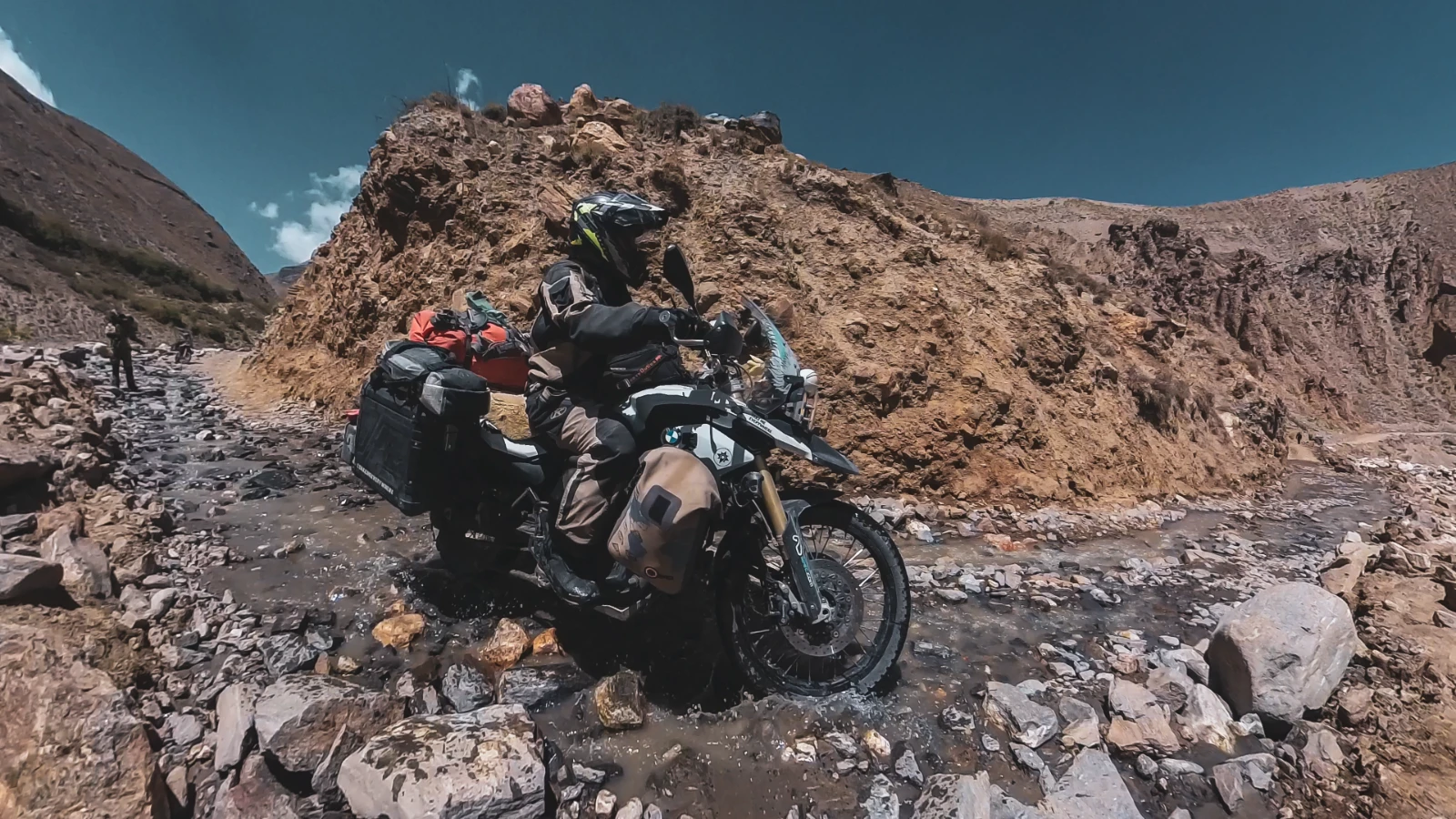 Flooded road on the Pamir Highway, river crossing with the motorcycle crew
