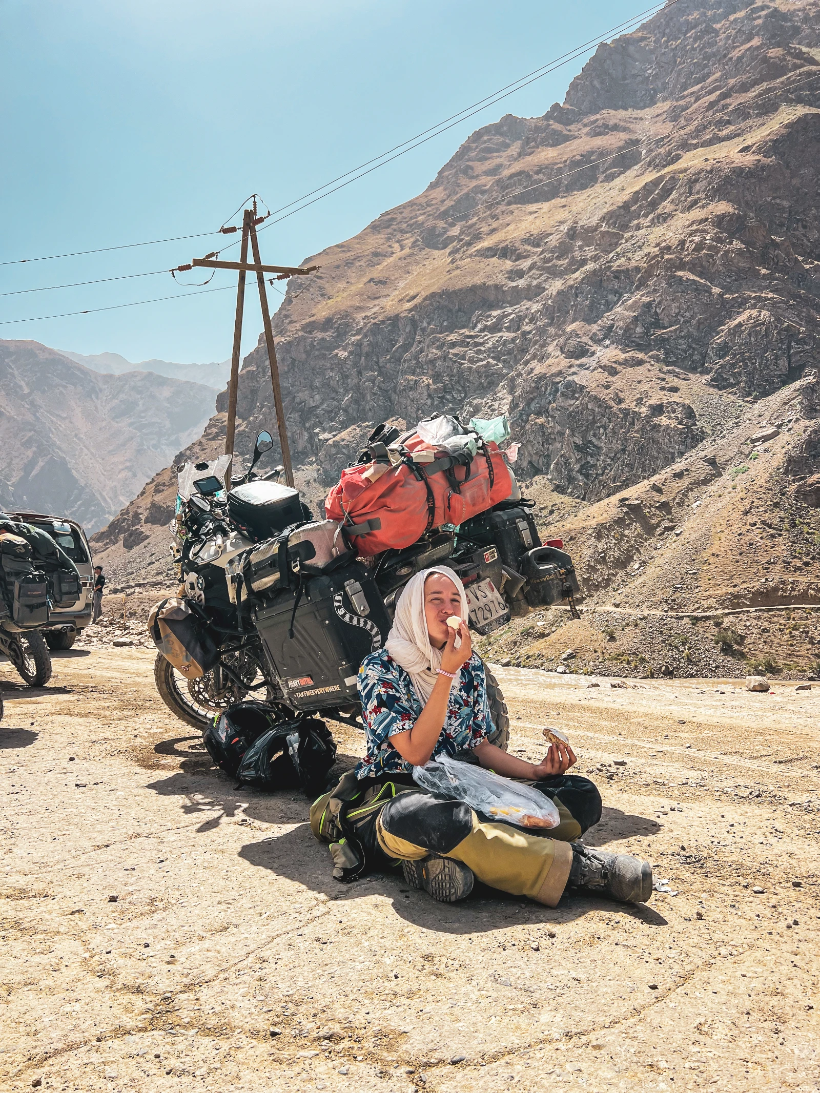 Road closed in the heat, waiting in the shade of the motorcycle