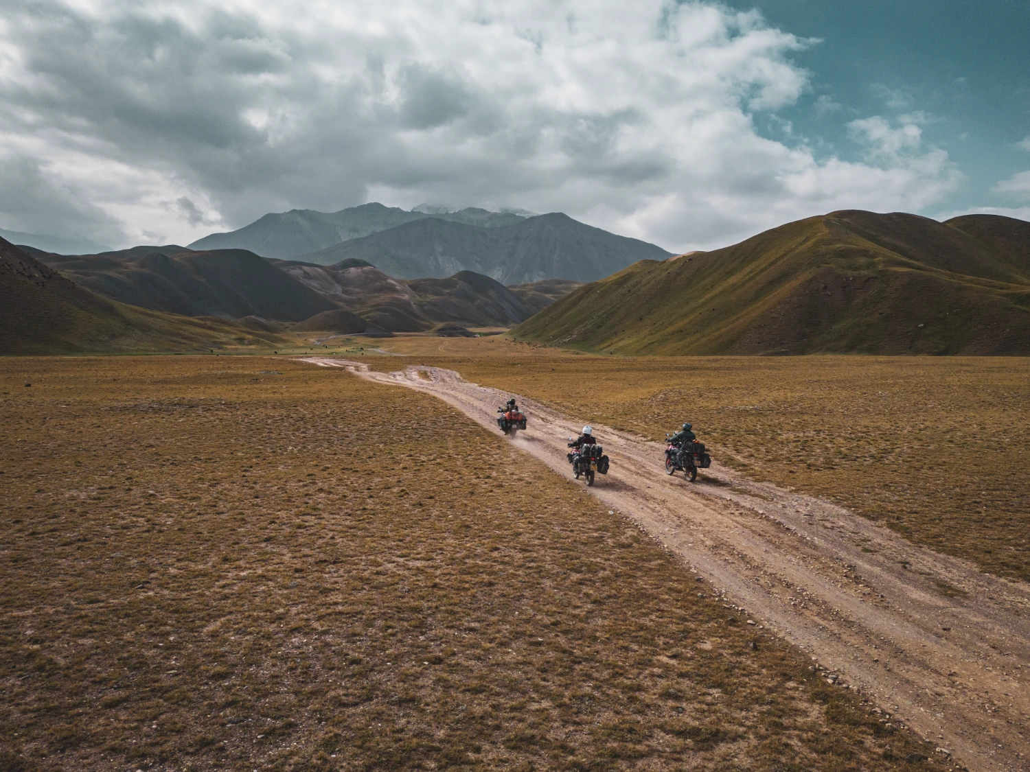 motorcycle travel Kyrgyzstan nomadic steppes sunset
