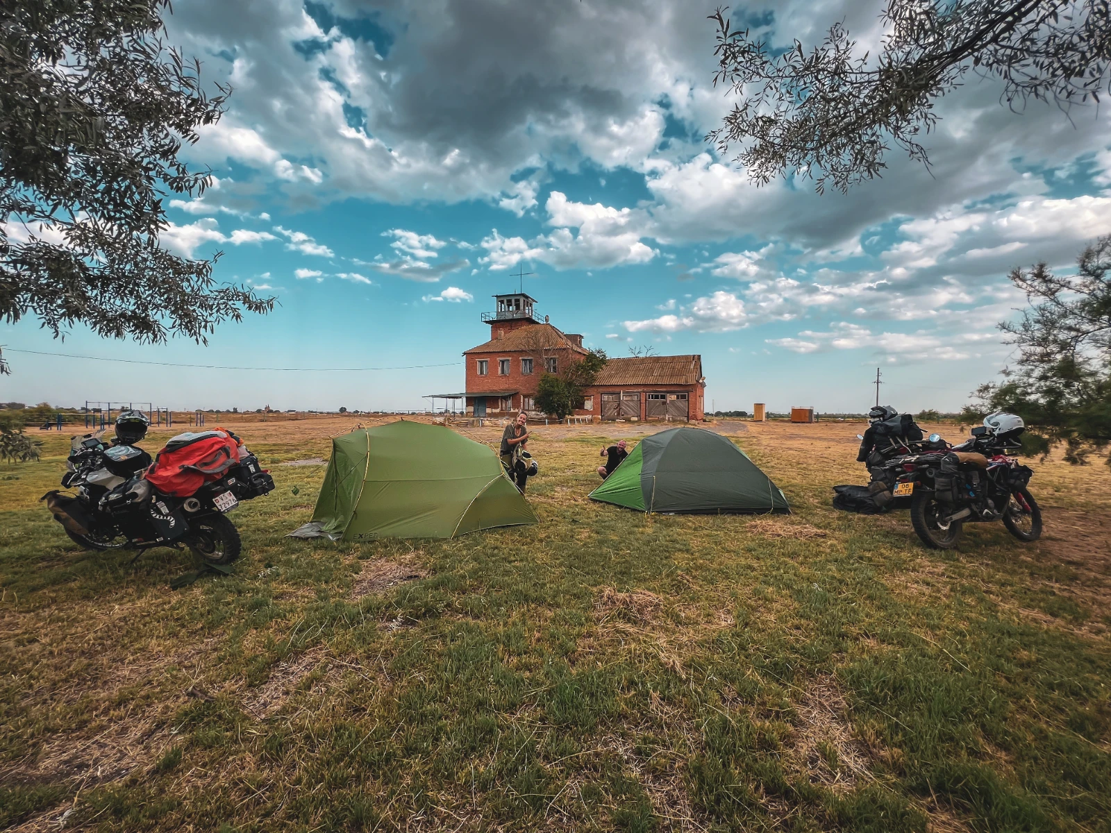 Motorcycles parked at our wild camp spot near an abandoned house in Lagan, Kalmykia