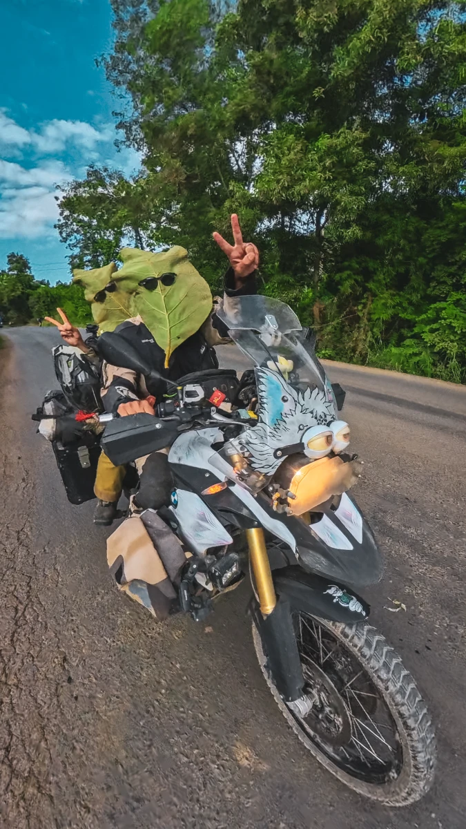 Laos riding humor leaf as helmet